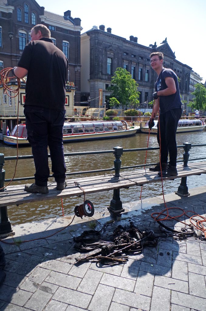 Searching for treasure with magnets in a canal, Amsterdam